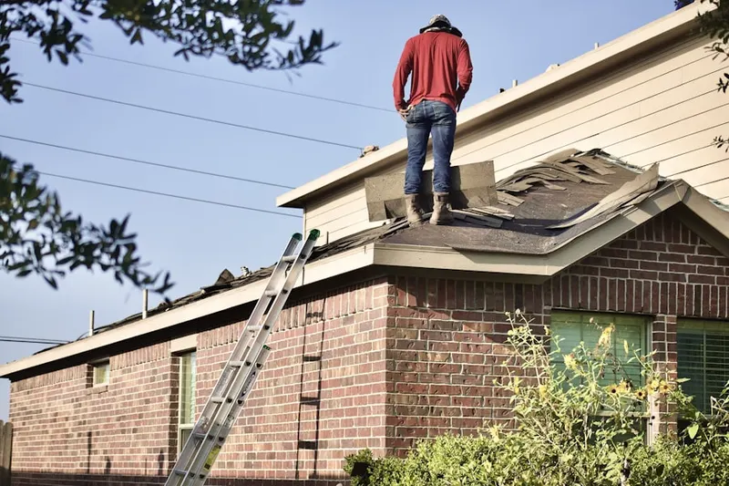 Professional roofer working on a residential roof in Boca Raton Square